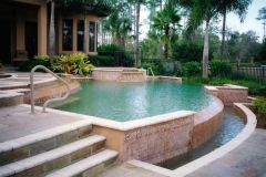 Vanishing edge swimming pool, spa, water feature, deck, tile and pebble interior