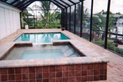 Raised added spa and pool with brick paver deck