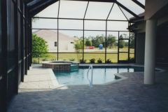 Screen Cage, paver deck, raised spa, swimming pool interior, tile and coping