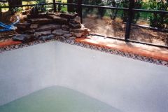 rock waterfall under construction with swimming pool renovation