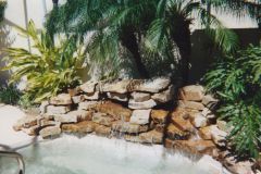 rock waterfall added to swimming pool