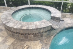 travertine spa with tile and spillover
