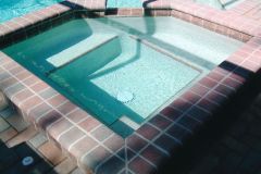 large spa with benches, coping, pebble interior added to swimming pool remodel