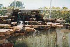 rock waterfall under construction with swimming pool renovation including tile interior
