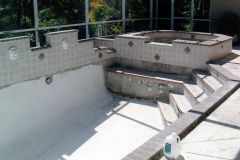 new spa addition to pool under construction, including pebble interior pool surface